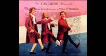 Howard Da Silva, William Daniels, and Ken Howard in a comedic pose, as if dancing, in front of an image of the Declaration of Independence, overlaid with transparent red, white, and blue stripes.