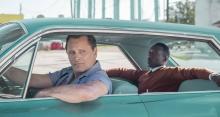Viggo Mortensen as Tony Lip driving a green car with Mahershala Ali as Dr. Don Shirley in the back seat.